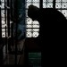 Mula lighting a lamp in a Kashmirian Mosque.  Kashmir, India